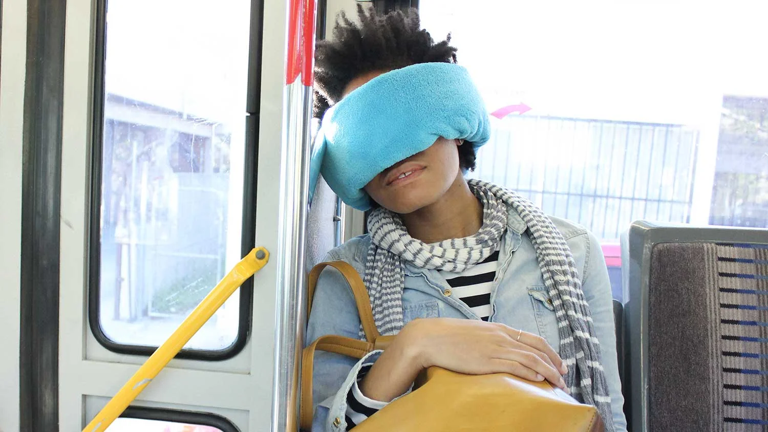 Teens napping on a bus with the Wrap-a-Nap